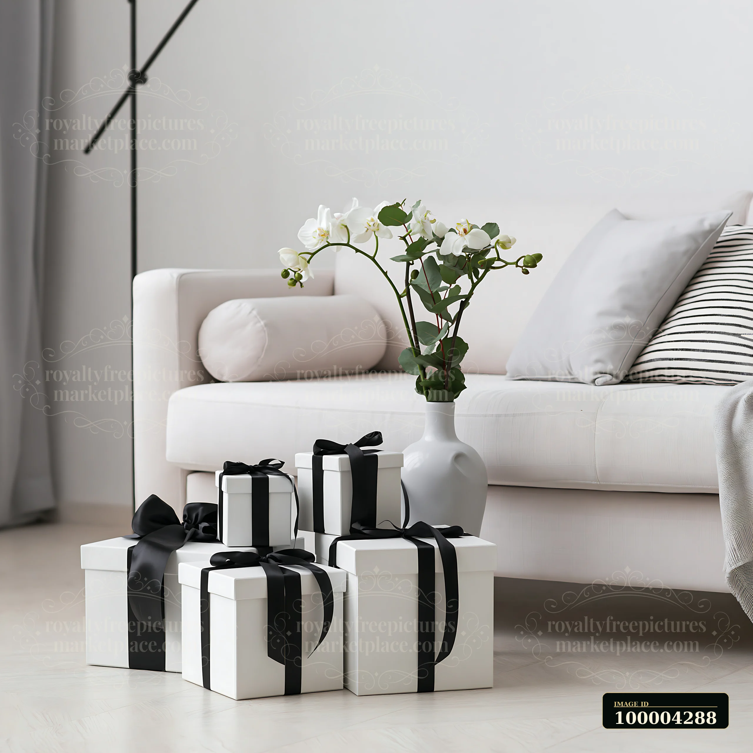 A collection of birthday gifts is arranged beside a modern sofa in a stylish room.