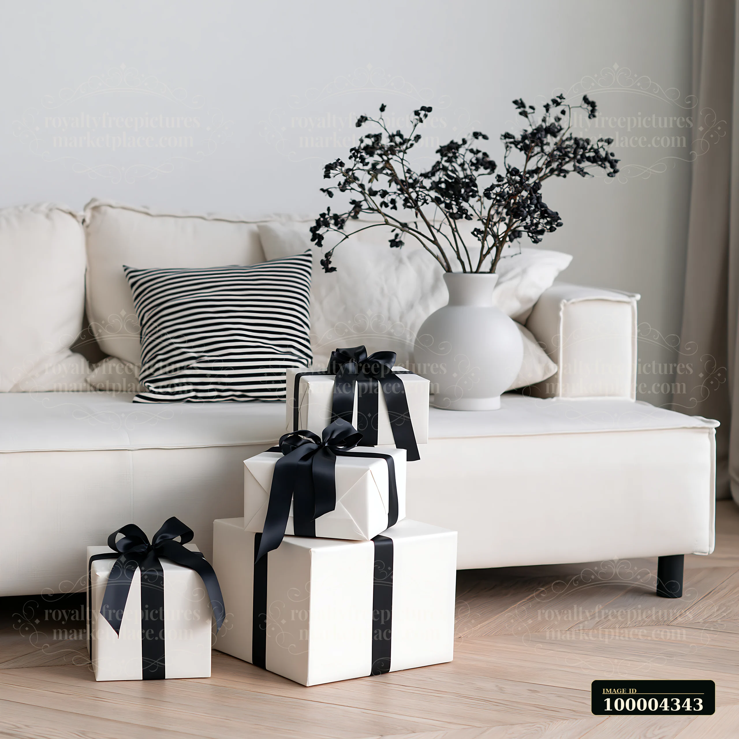 Wrapped gifts with black ribbons are placed beside a modern sofa in a bright living room.