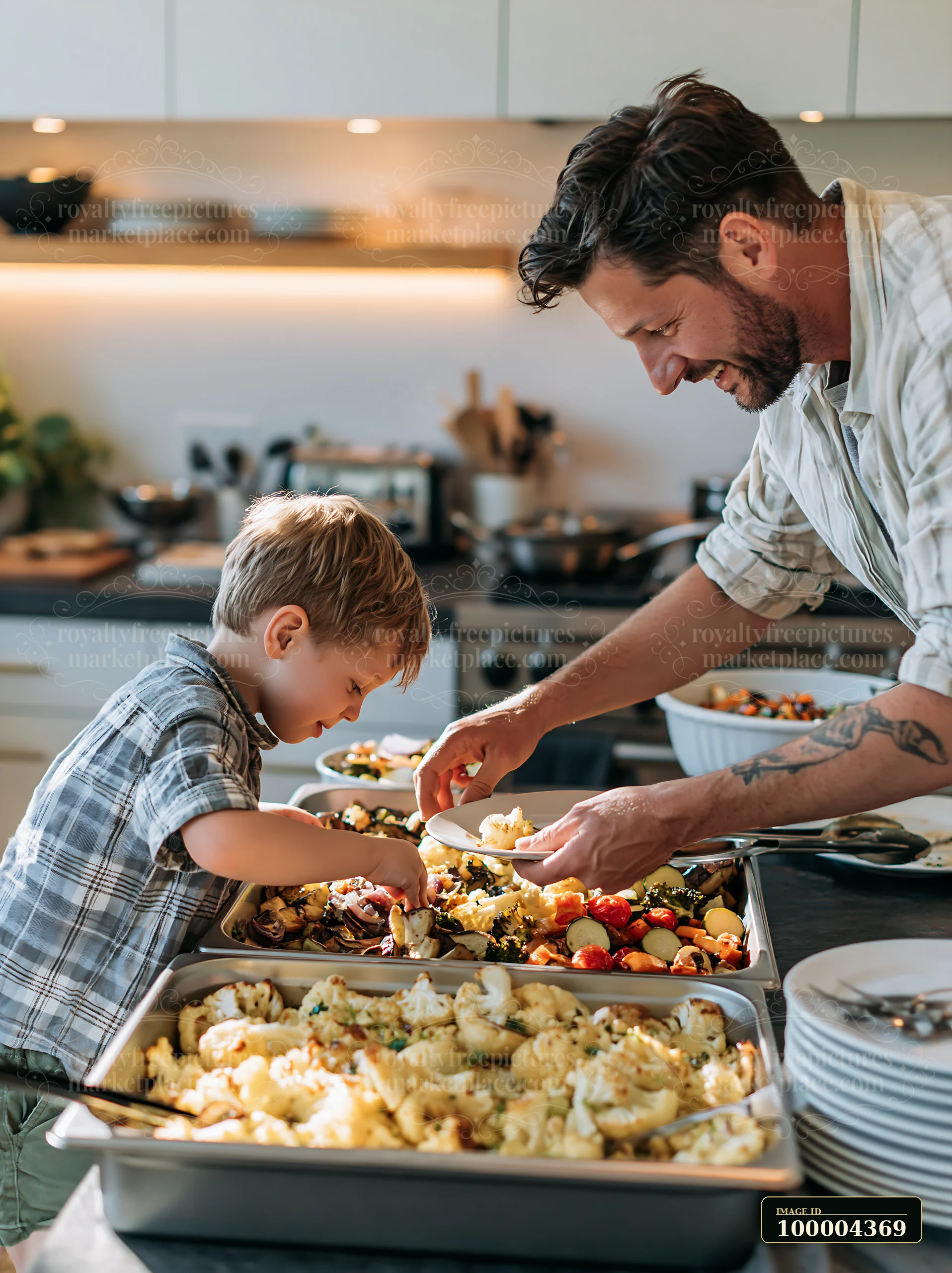 Father and child serving roasted vegetables from buffet trays in a bright home kitchen.