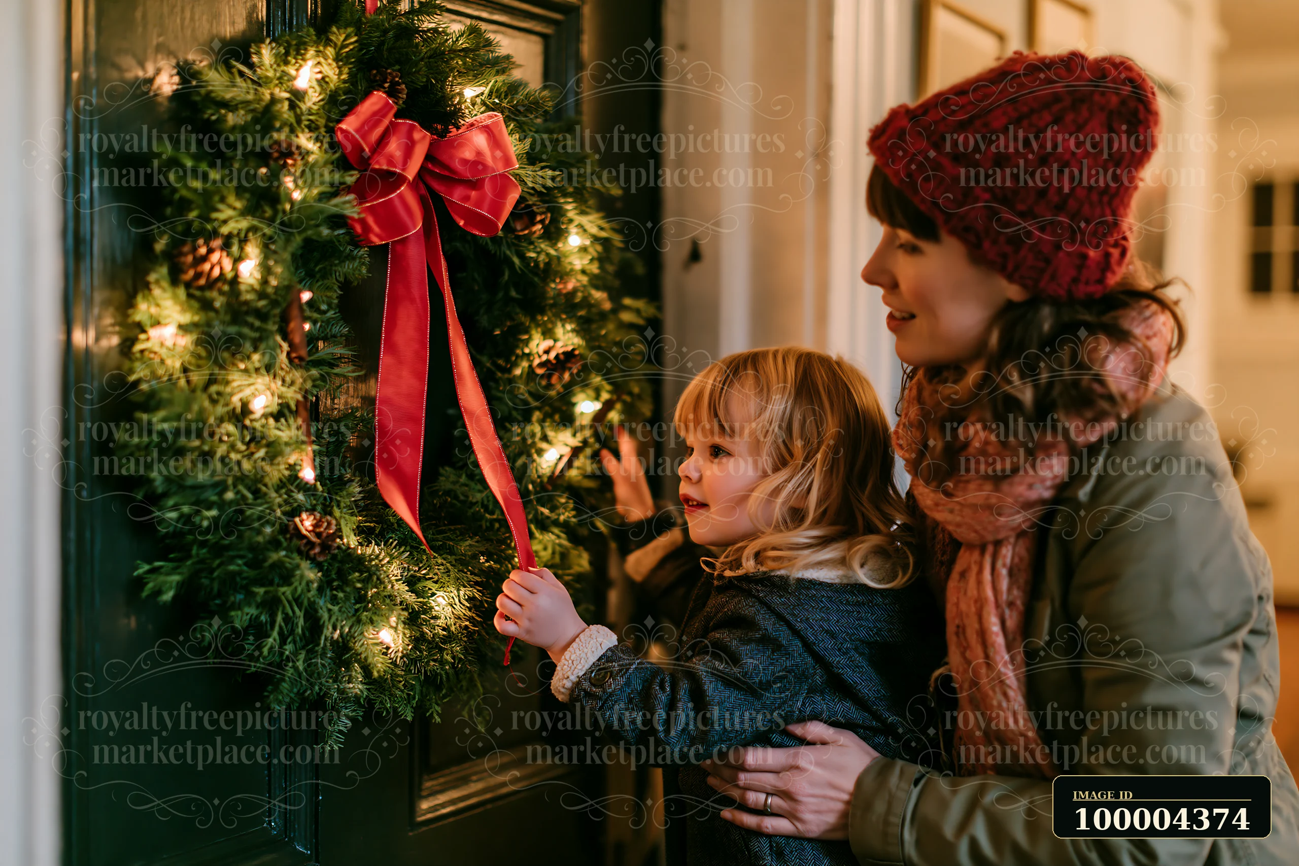 A child points at a Christmas wreath placed on an apartment door while an adult stands beside them.