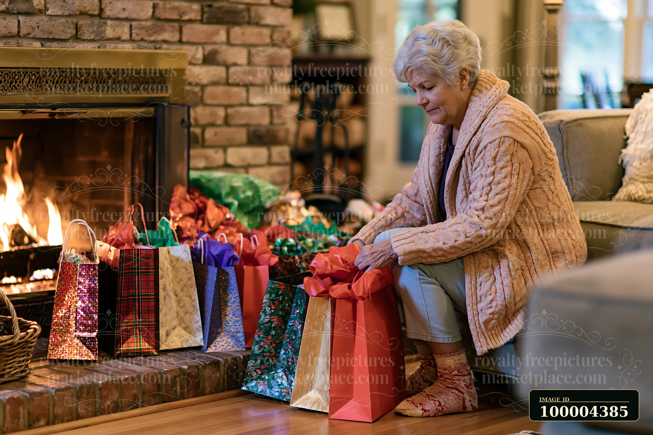 Older woman arranging colorful holiday shopping bags beside a lit brick fireplace in a cozy living room.
