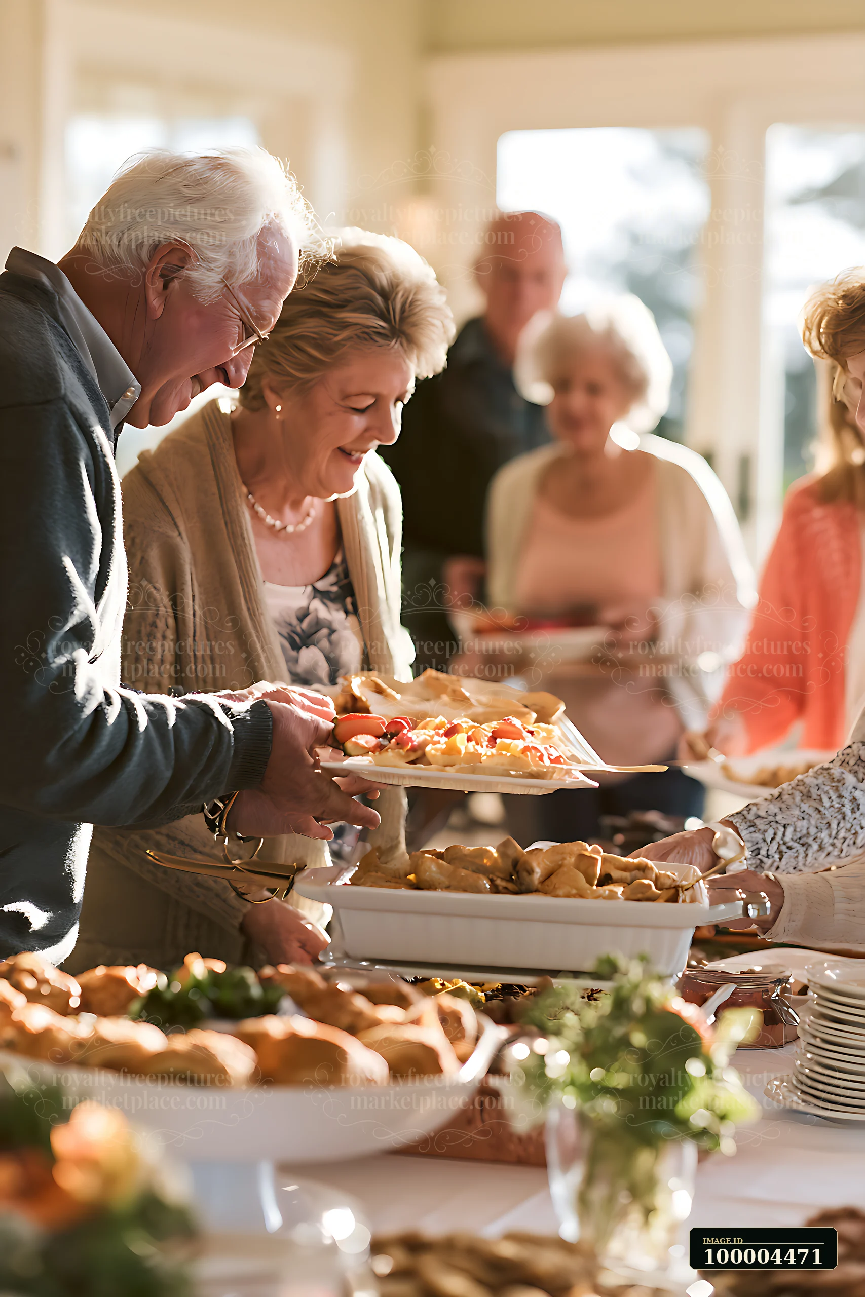 Seniors gather around a buffet table enjoying cookies and pastries at a celebration.