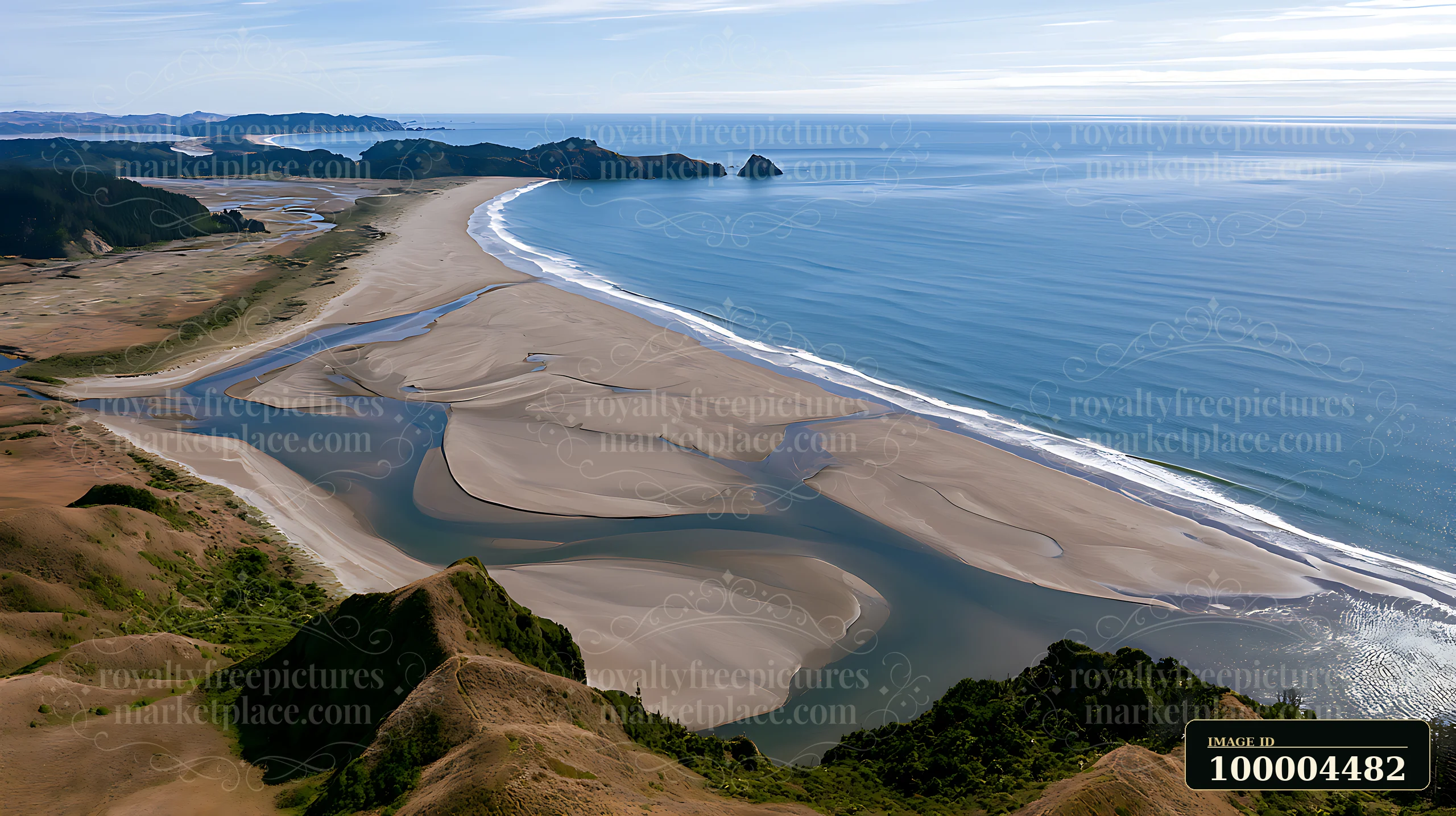 Aerial view of a sandy coastline with a winding tidal river, ocean waves, and forested headlands.