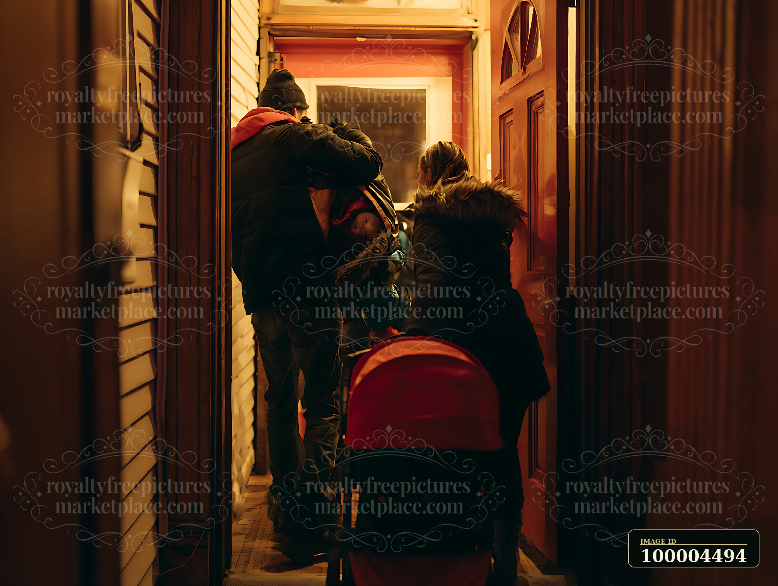 Parents are bringing a sleeping child inside their home on Christmas Eve.