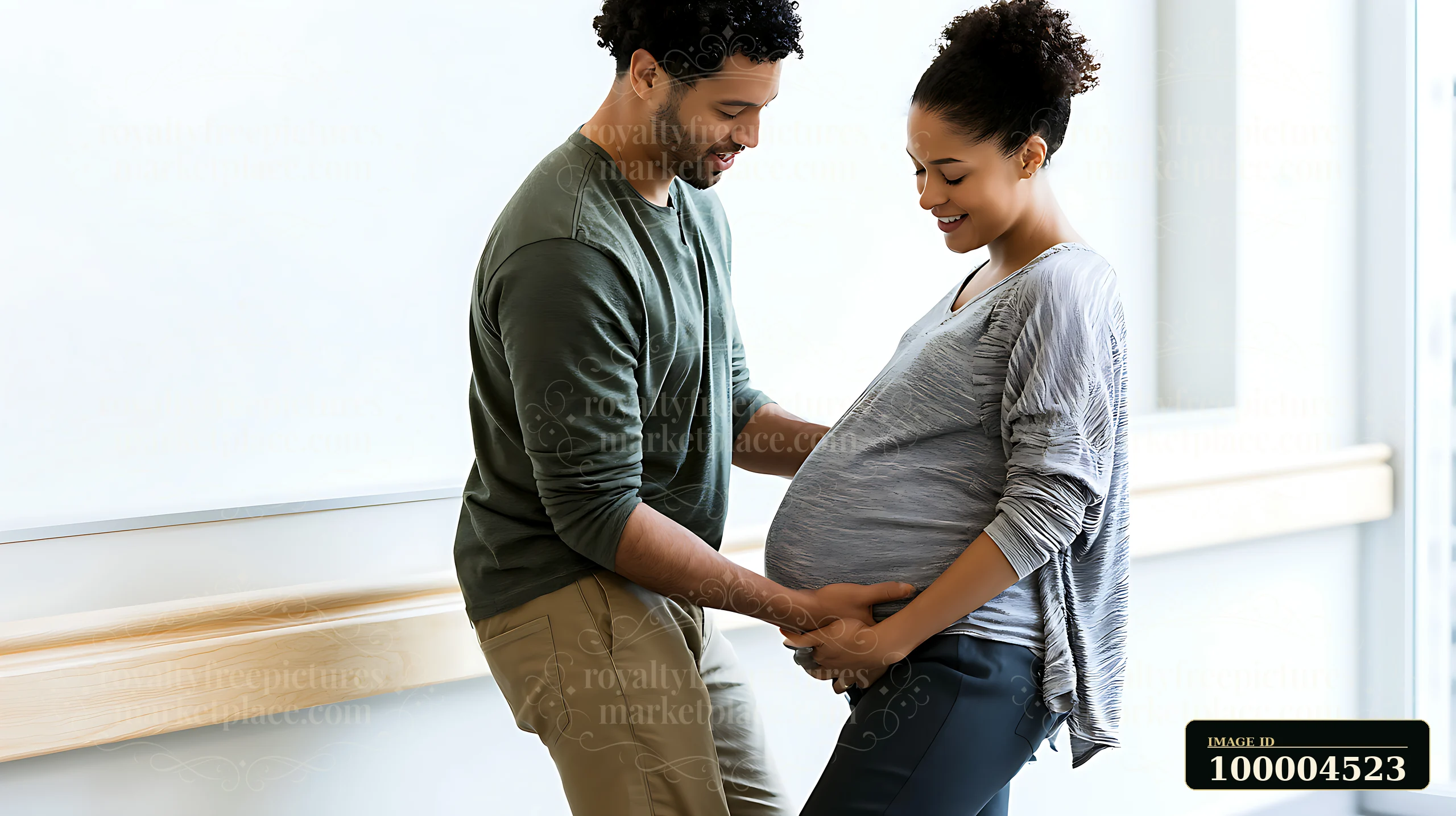 Pregnant couple practices supportive touch during a childbirth class in a bright healthcare setting.