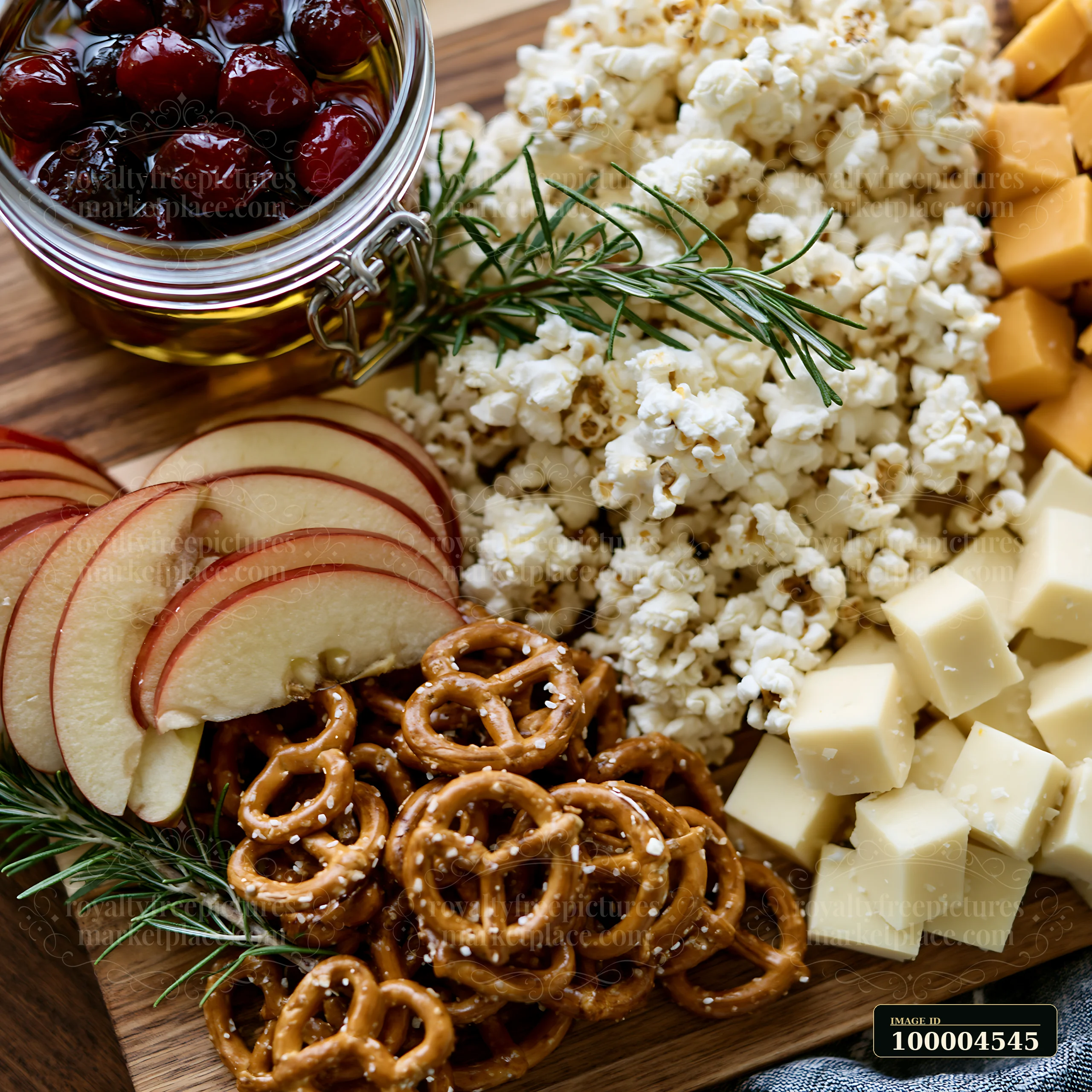 A serving board displays popcorn, apple slices, pretzels, cheese cubes, and cherries.