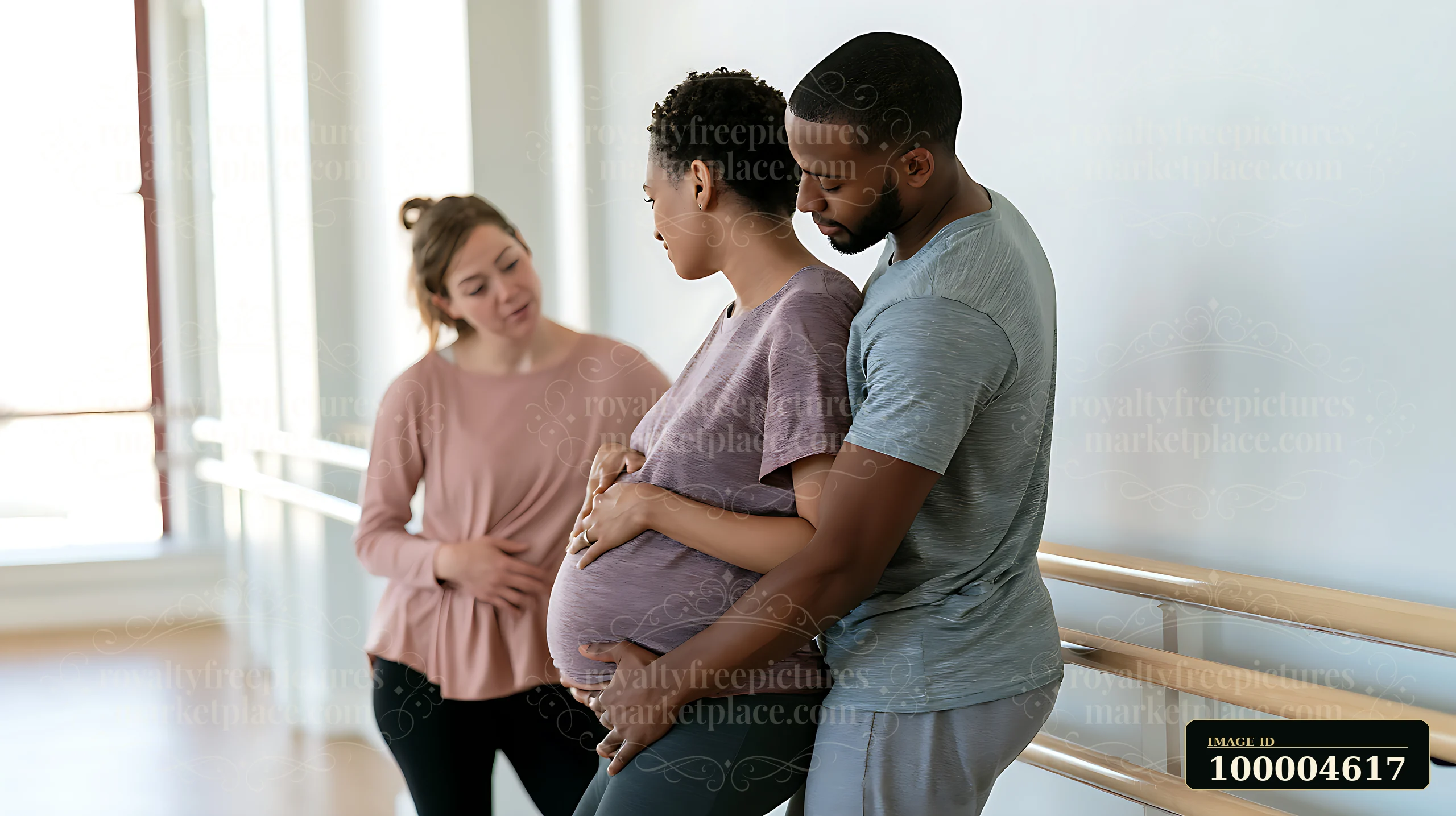 A pregnant couple listens to an instructor during a childbirth class.