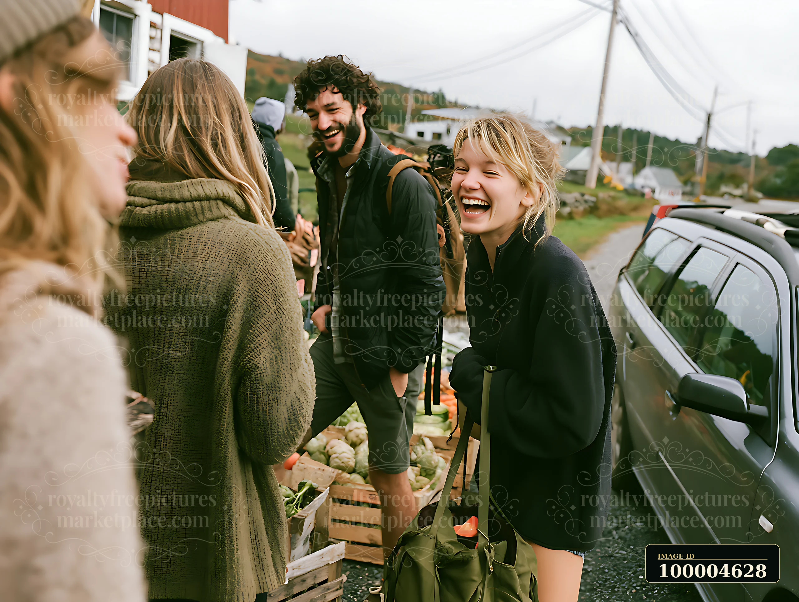 Four friends laugh beside a parked car during a rural roadside stop with green hills behind them.