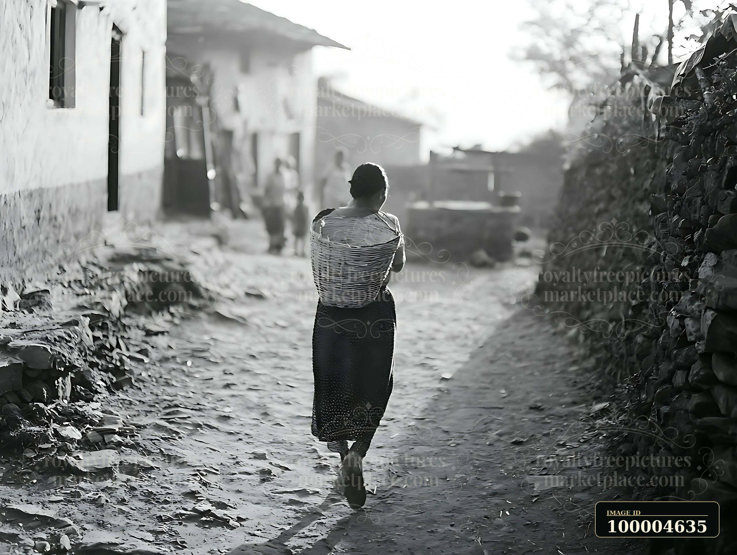 Woman in traditional dress walks away along a rural dirt path carrying a large woven basket.