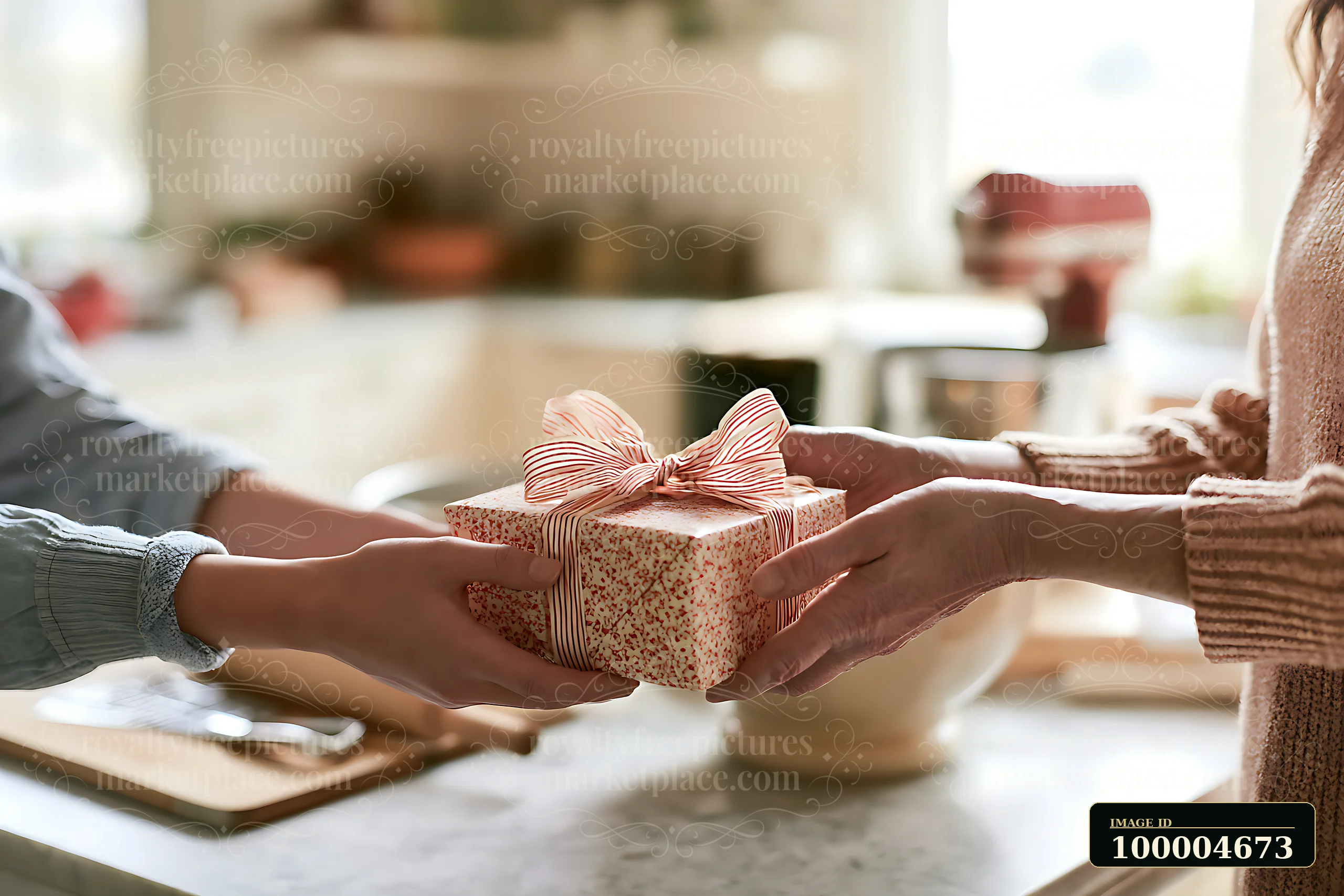 Two pairs of hands exchange a wrapped holiday gift across a bright kitchen counter.