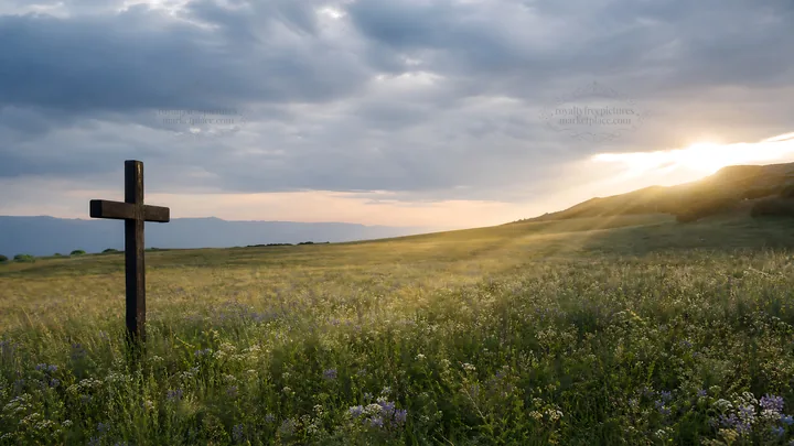 Christian cross in meadow with light rays at sunset - AI-generated stock image
