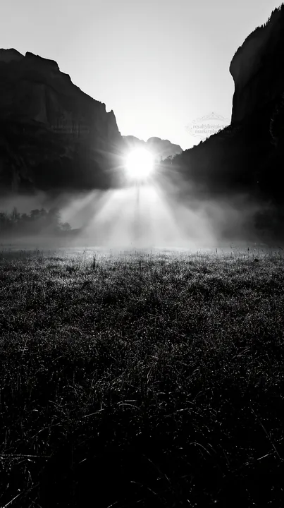 Black and white lauterbrunnen Valley meadow light rays create morning glow - AI-generated stock image