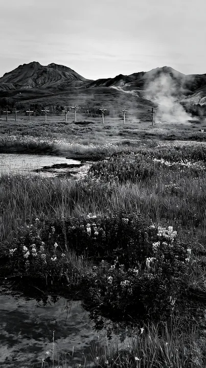 Christian crosses near geothermal springs in a meadow - AI-generated stock image