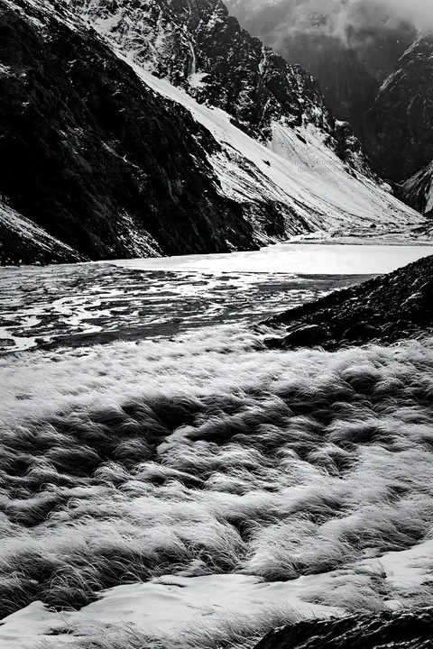 Frozen tarn meadow in winter landscape - AI-generated stock image