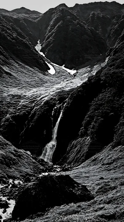 Snowmelt waterfall in Toyama alpine meadow with rocky foreground - AI-generated stock image