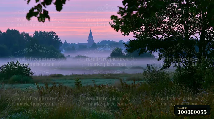 Fog drifts across a meadow at twilight, revealing a village church and homes beneath a pink-purple sky.