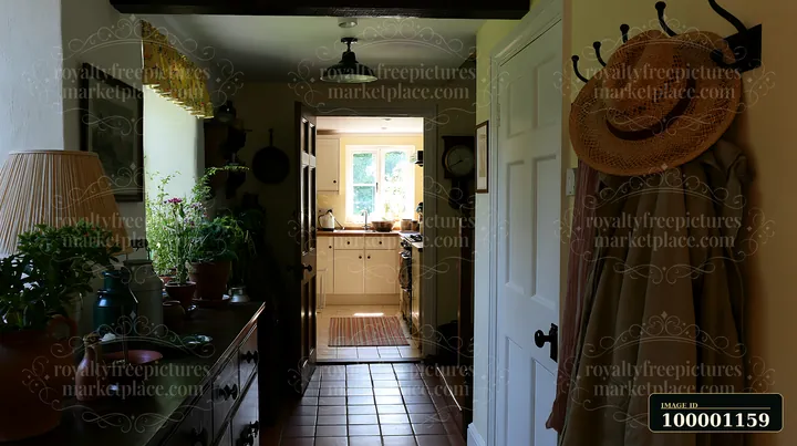 This hallway features coat hooks and leads to a bright kitchen area.