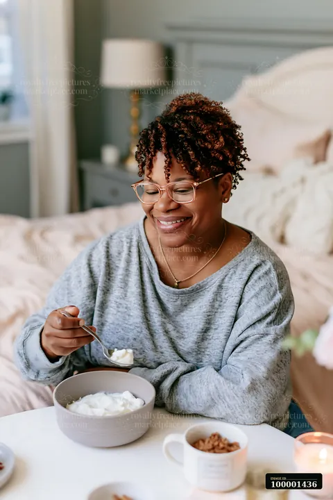 A person with limited hand mobility using utensils enjoys a meal at a cozy table setting.