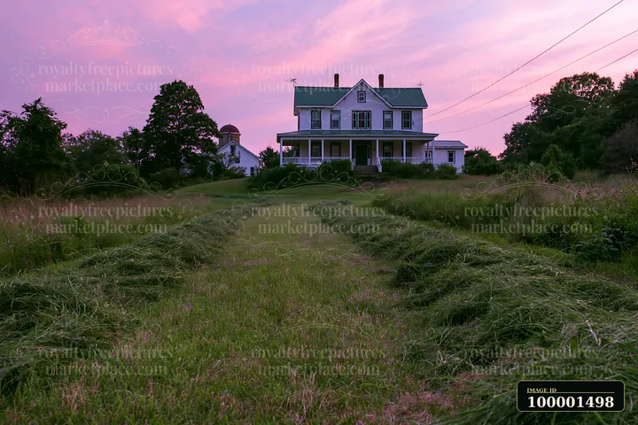 A farmhouse stands in the distance with a mowed path leading towards it under a vibrant sunset sky, showcasing shades of purple and pink.