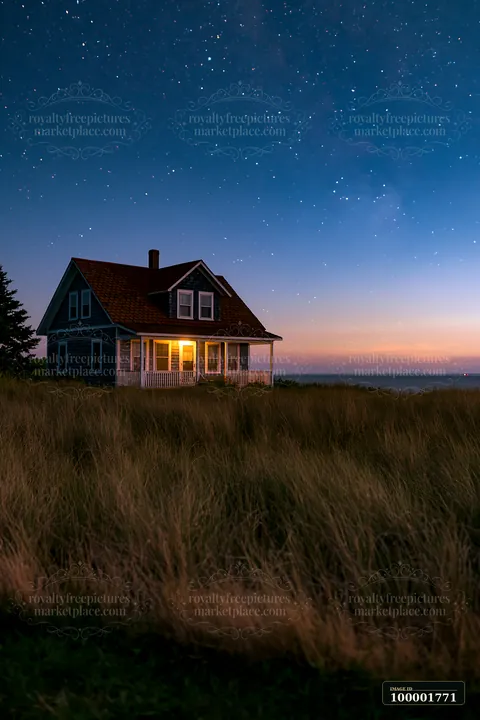 A lighthouse house under stars stands in a field at dusk, with warm light glowing from its windows.