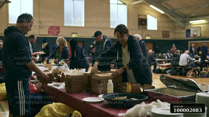 Volunteers prepare and serve food at a charity event buffet in a community hall.