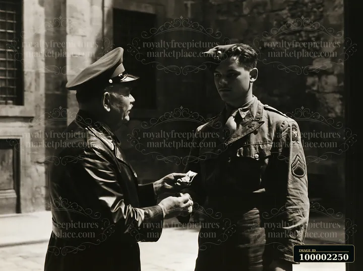 A soldier receiving medal stands attentively as a superior officer presents an award.
