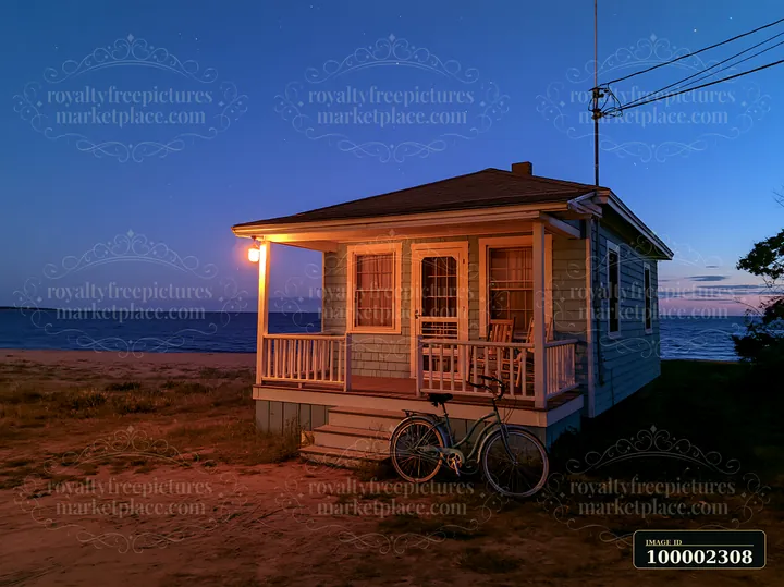 A beach house sits near the water during twilight.