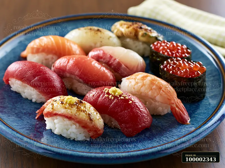 This close-up showcases a variety of sushi pieces on a blue plate.