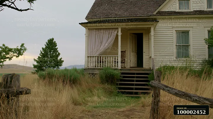 A country house with an open front door shows a welcoming entrance and a porch with a rocking chair.