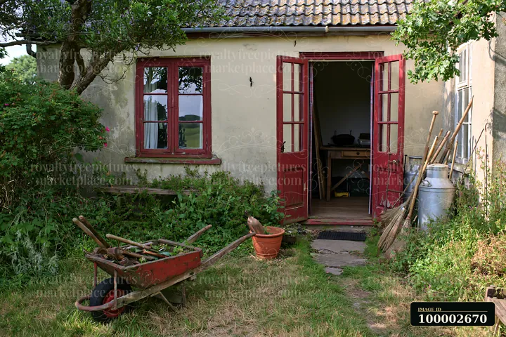 A country house with open front door shows a glimpse of the interior.