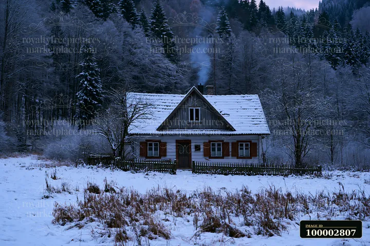 A rustic house with wooden shutters stands in a snowy field.