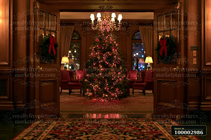 A beautifully decorated Christmas tree in a hotel lobby stands at the center, surrounded by festive decor and seating areas.