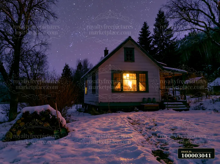 A cozy home is lit up from within, surrounded by snow and trees, under a clear winter night sky filled with stars.