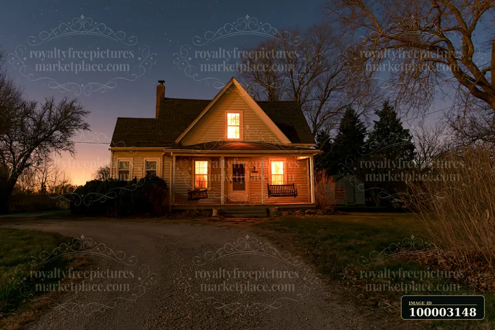 A house with porch swing under starry sky shows a peaceful evening scene with warm lights glowing from the windows.
