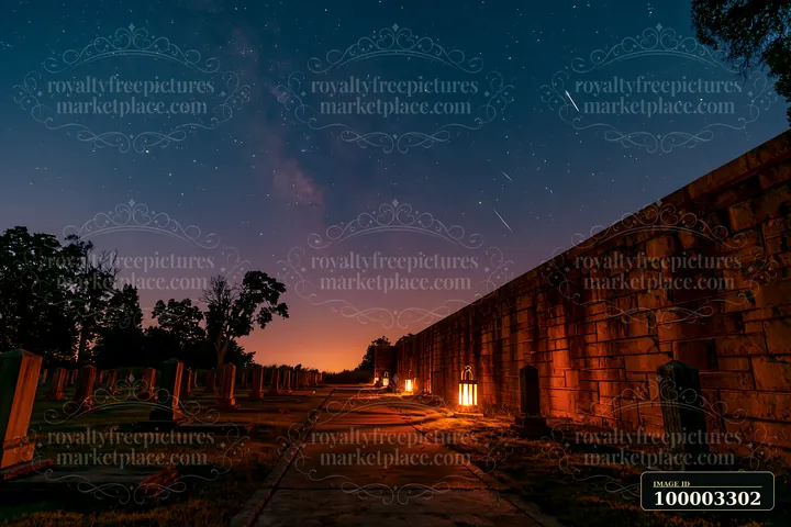 A view of a soldiers' cemetery at night, featuring stars and shooting stars in the sky.
