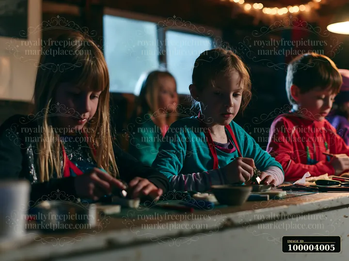 Several children craft handmade ornaments at a workshop.