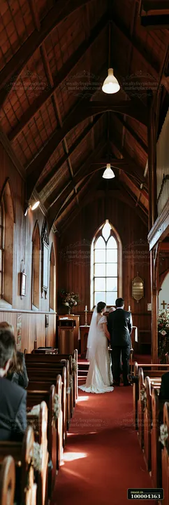 Bride and groom stand at the altar during a ceremony inside a warmly lit wooden chapel.