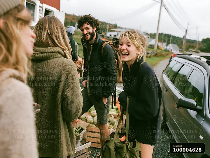 Four friends laugh beside a parked car during a rural roadside stop with green hills behind them.
